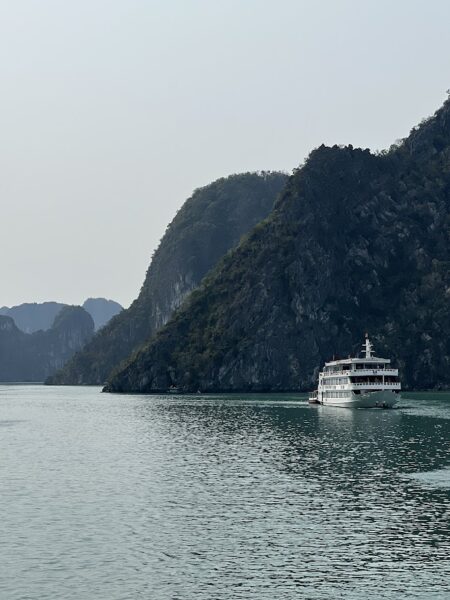 Budget cruise boat sailing through Ha Long Bay in Vietnam.