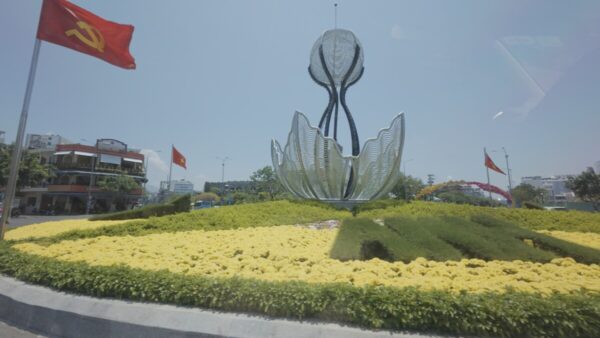 Roundabout with flower sculpture and flags