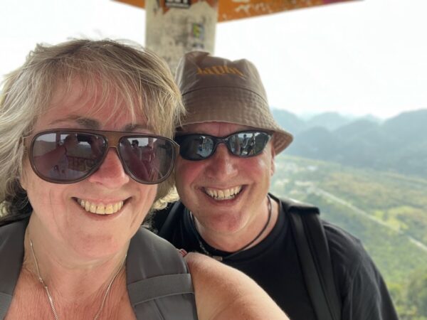 Happy travellers exploring Cat Ba Island by scooter