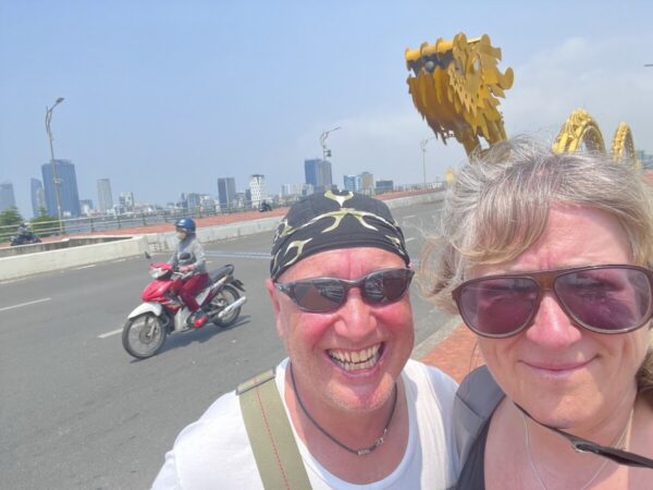 Travellers smiling on Dragon Bridge in Da Nang
