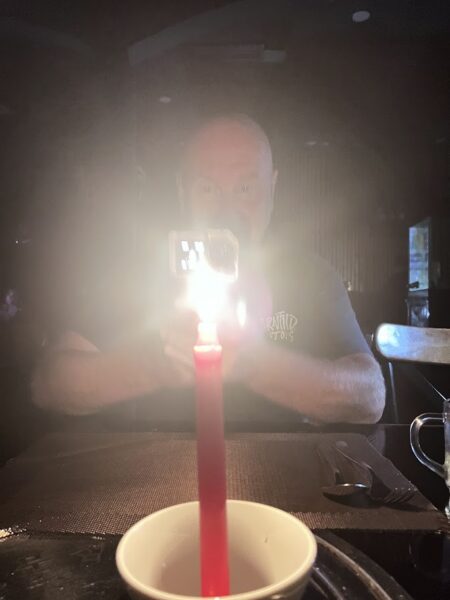 Candlelit dinner with glowing red candle on the table