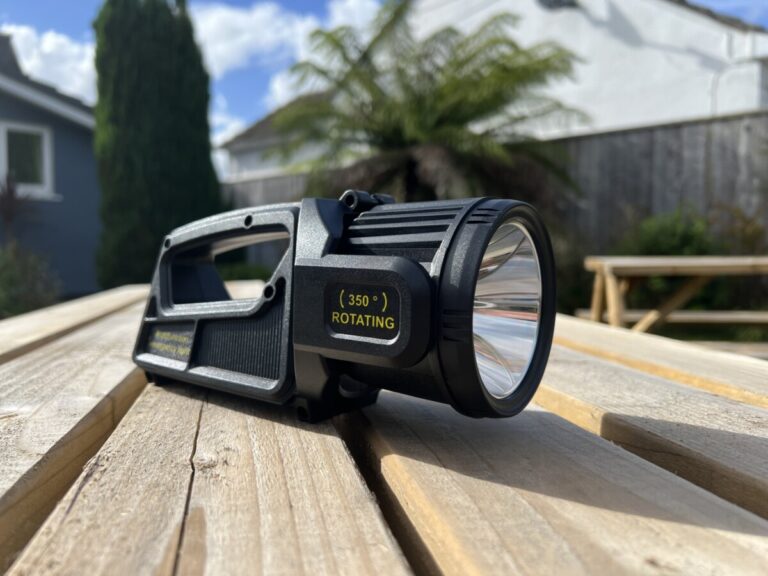 Close-up of the LETOUR rechargeable torch on a wooden bench outdoors
